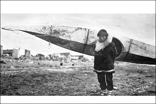 Inuit carrying kayak